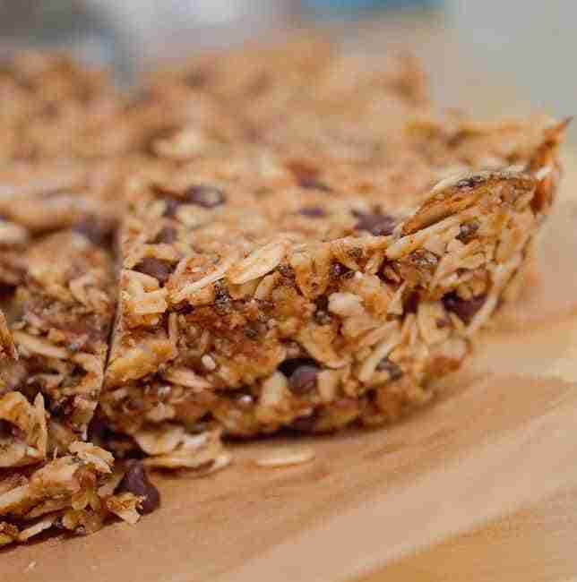 Homemade healthy granola bars against butcherblock countertop background