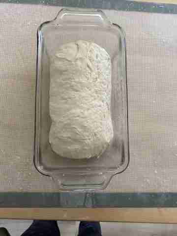 rolled loaf of bread dough in pan