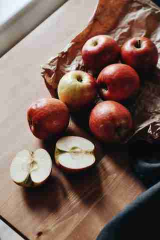fresh apples against butcher block background for making slow cooker applesauce