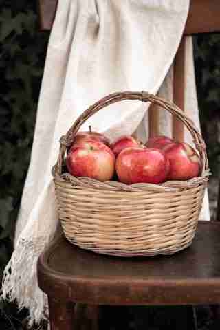 fresh apples in brown basket for homemade applesauce